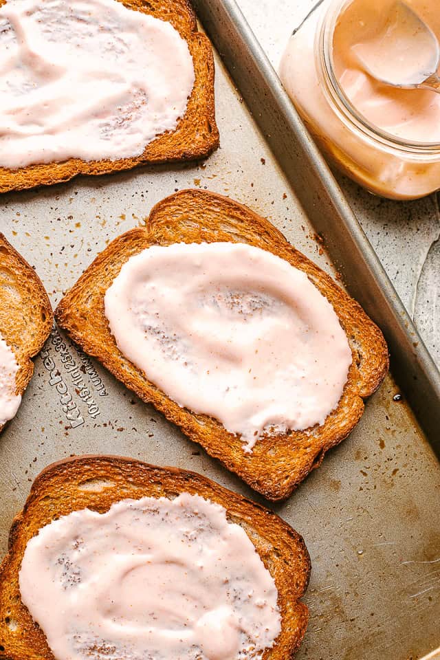 Russian dressing spread over slices of rye bread.