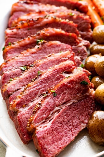 slow cooked corned beef sliced and served with potatoes and carrots