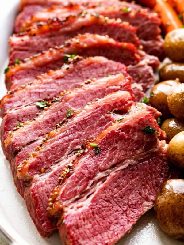 slow cooked corned beef sliced and served with potatoes and carrots