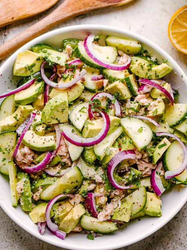 serving tuna avocado salad in a white bowl