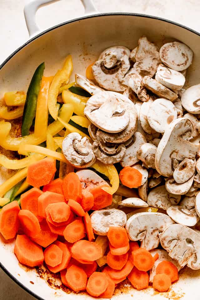 Sliced veggies in a pan ready to be sauteed. 