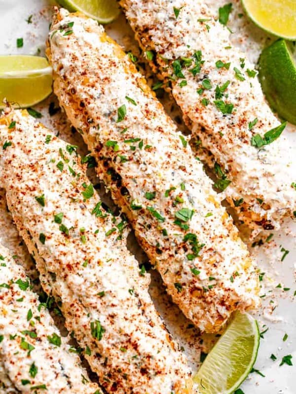 ELOTE corn served on a platter with lime wedges
