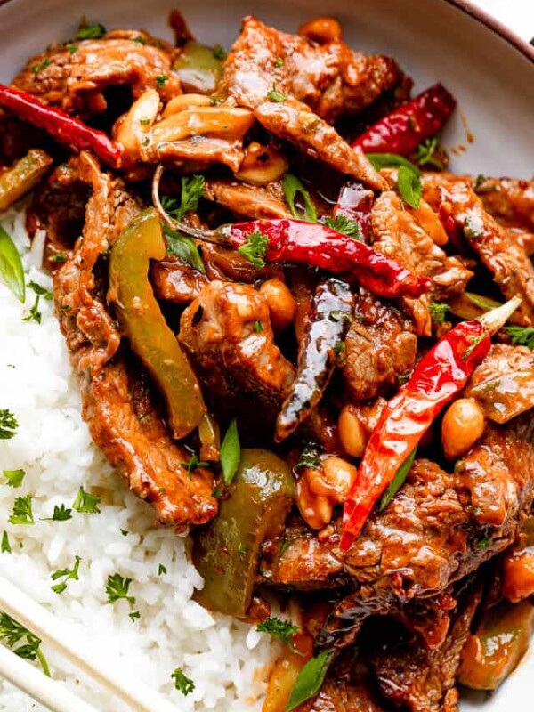 close up shot of Kung Pao beef served on a plate with a side of white rice.