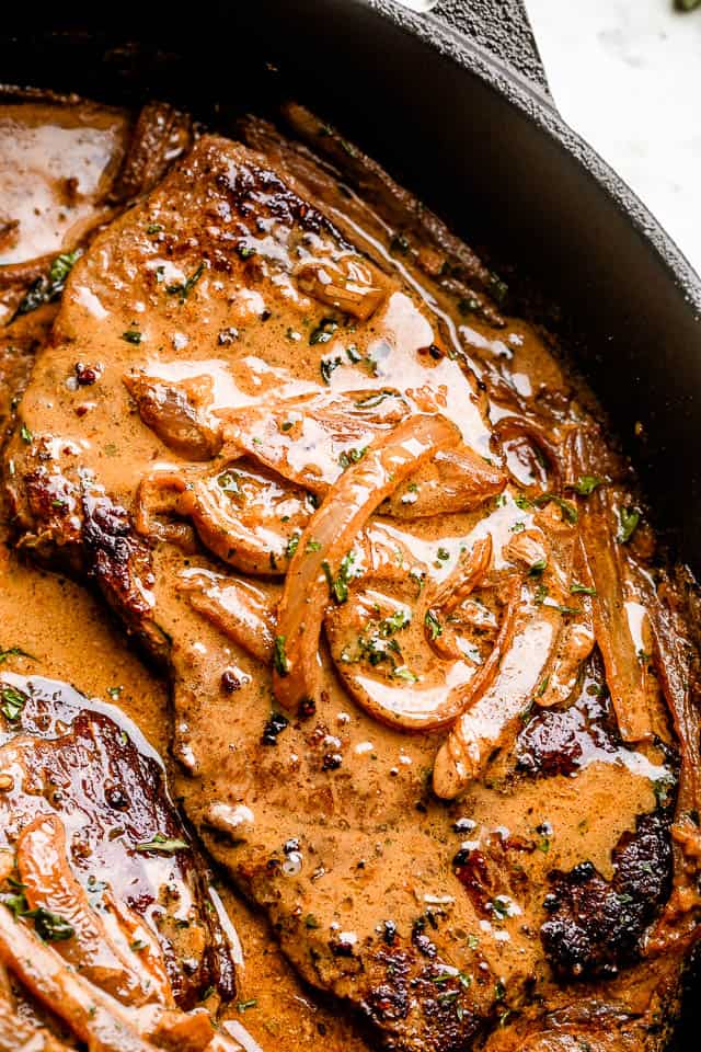 Skillet with finished smothered steak