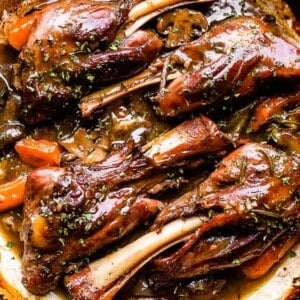 cooked lamb shanks in a pan