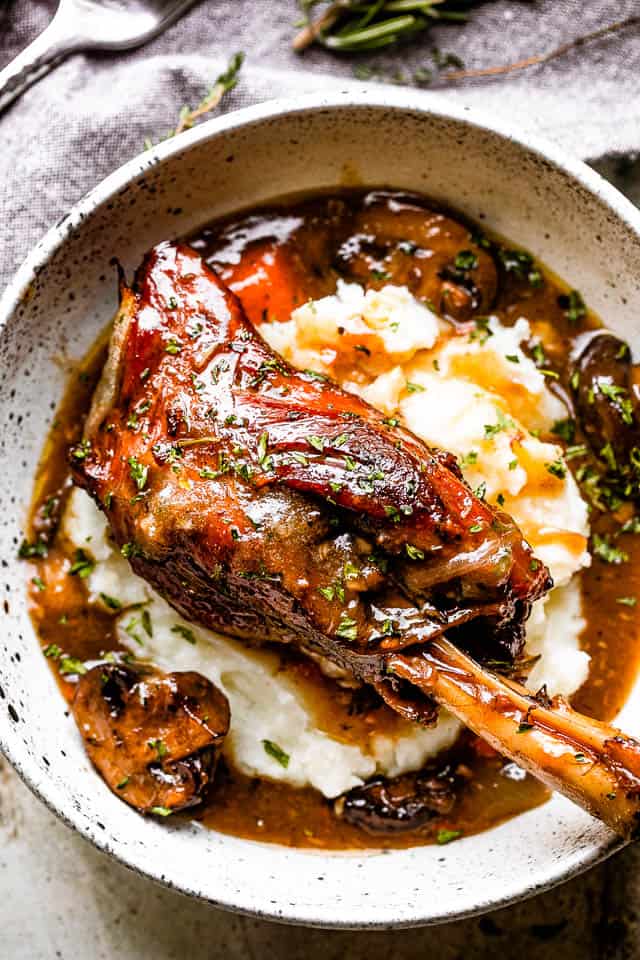 Lamb shanks served over mashed potatoes