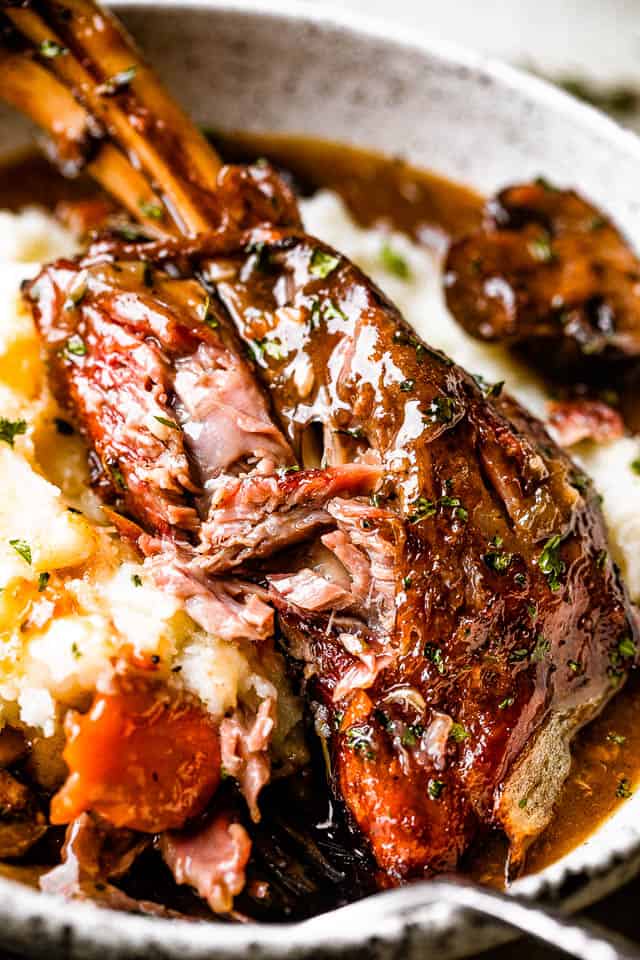 lamb shank served with mashed potatoes