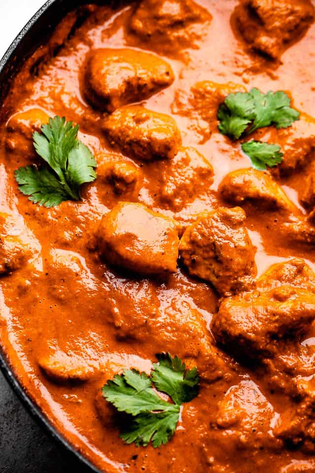 Close up view of chicken tikka masala in a skillet