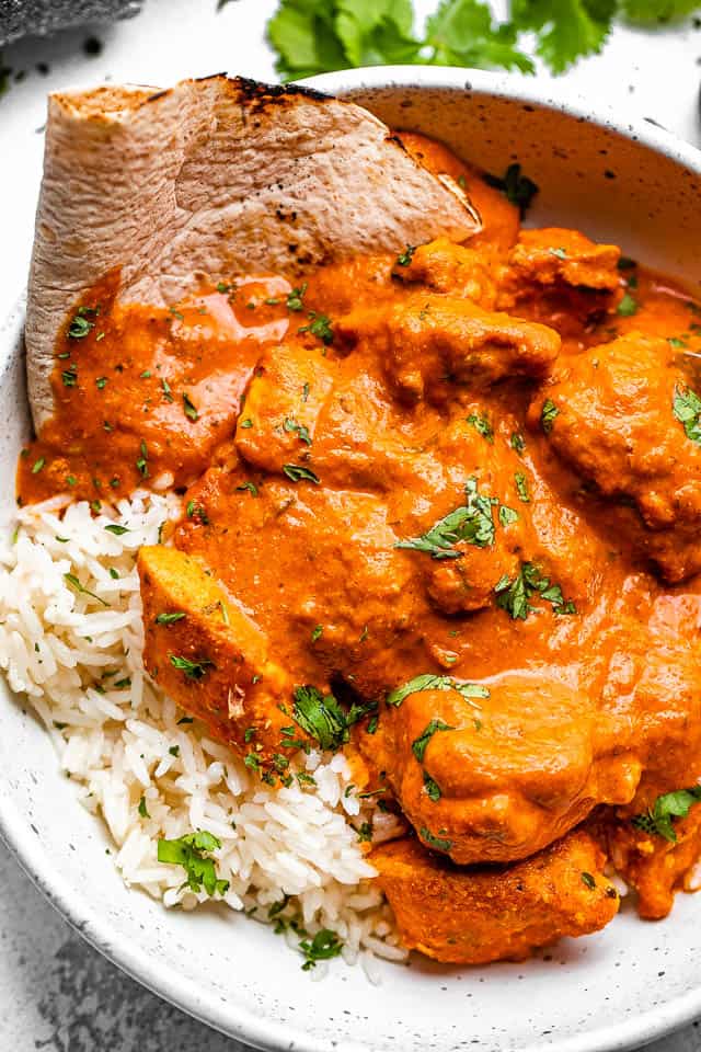 A bowl of chicken tikka masala with rice