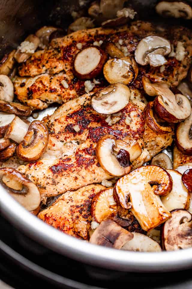 preparing chicken breasts and mushrooms in the instant pot