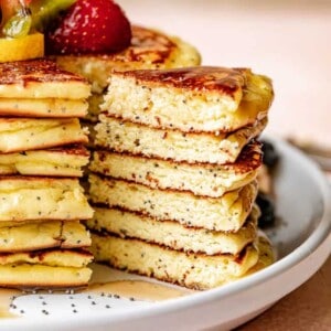slicing out a stack of lemon poppyseed pancakes