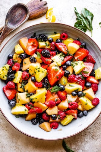 Top view of a mixed berry fruit salad with melon and pineapple