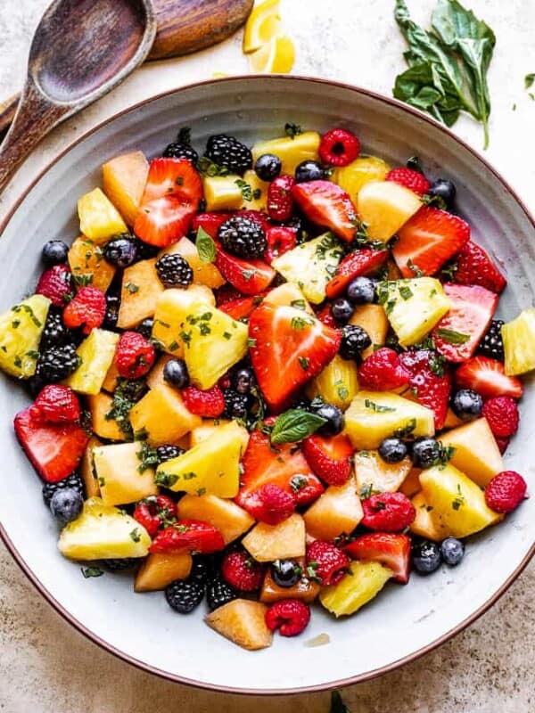 Top view of a mixed berry fruit salad with melon and pineapple