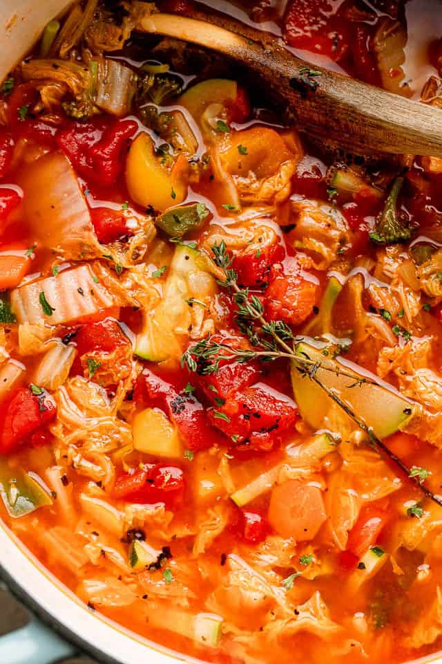 This easy cabbage soup recipe is packed with tender veggies simmered in a flavorful tomato broth. It’s hearty, delicious, and ready in 30 minutes! Close-up of homemade cabbage soup with cabbage, zucchini, carrots, broccoli, and fire-roasted tomatoes in a tomato broth.