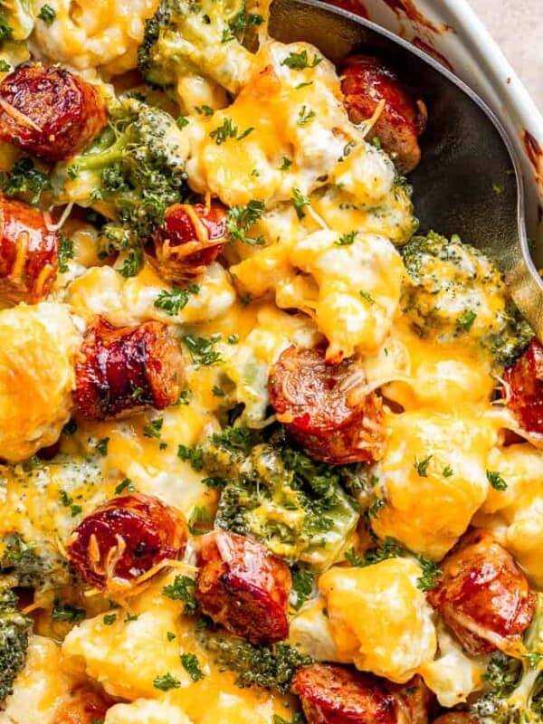 close up view of cauliflower broccoli casserole with sliced smoke sausages and cheese