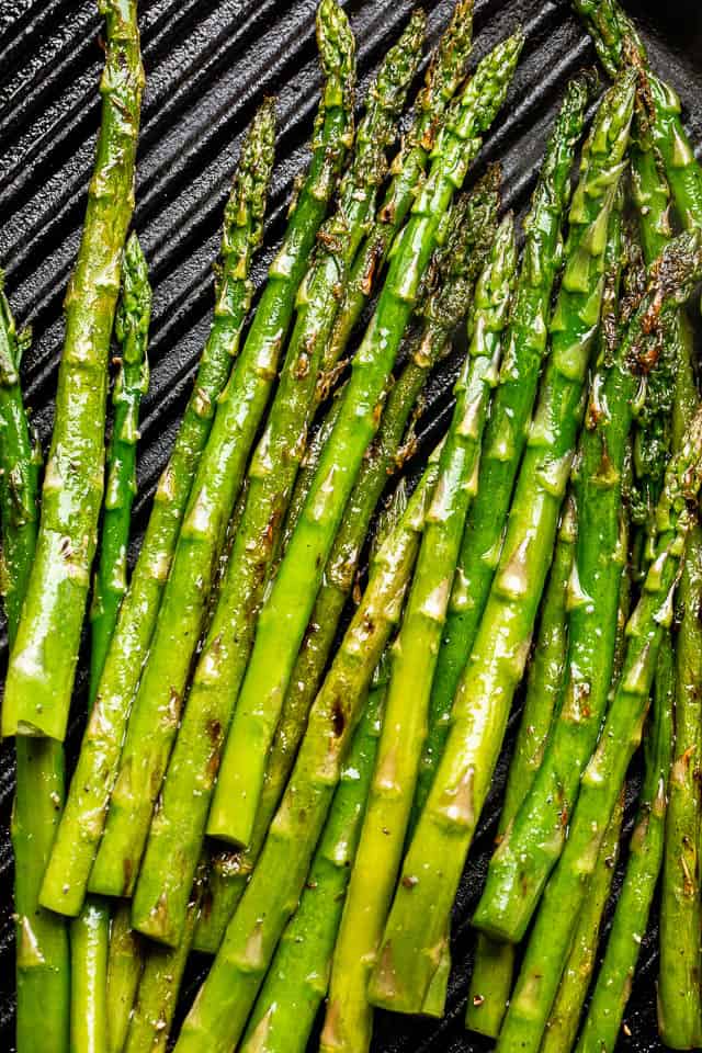 asparagus stalks set on black grill grates