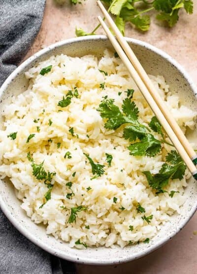 top view of instant pot cooked jasmine rice served in a bowl and topped with cilantro leaves