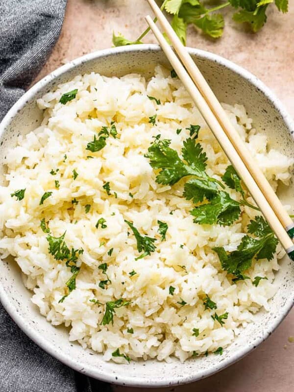 top view of instant pot cooked jasmine rice served in a bowl and topped with cilantro leaves