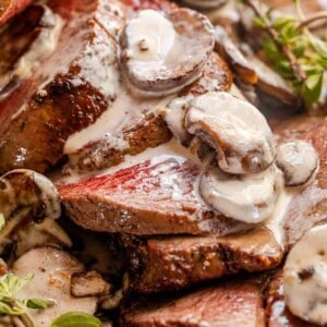 sliced beef tenderloin topped with mushrooms and gravy