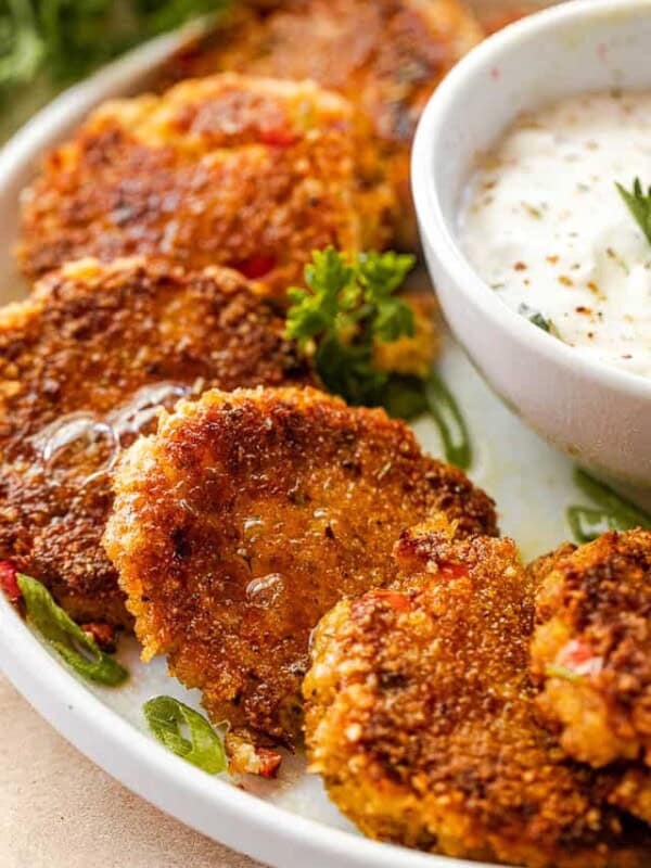 side shot of arranged crab cakes on a white plate