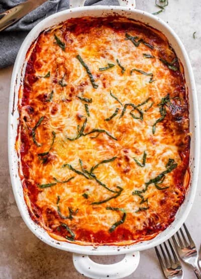 top shot of baked eggplant lasagna in a white baking dish