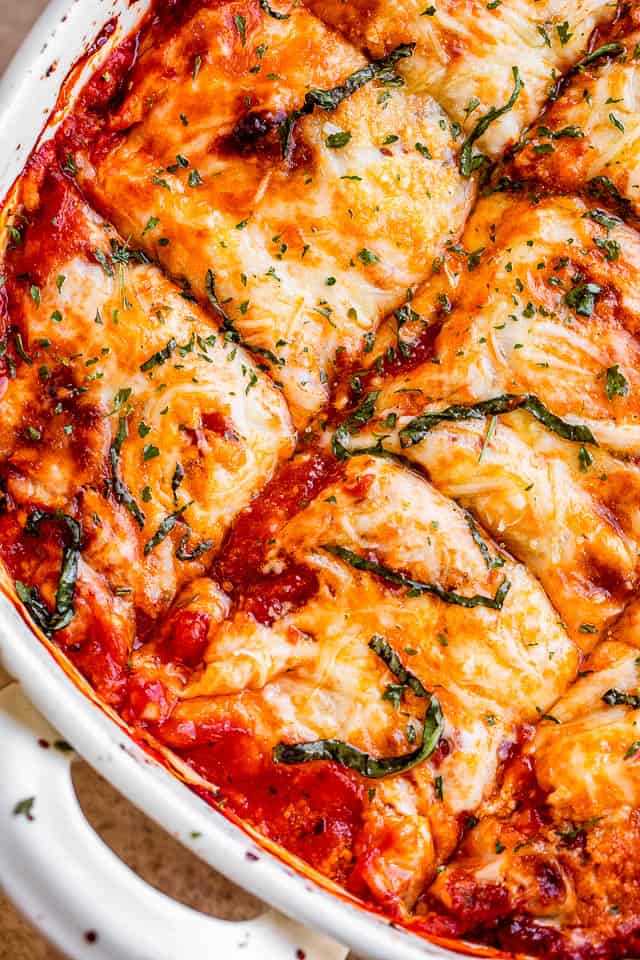 top shot of eggplant lasagna cut up into squares inside the baking dish