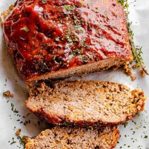 top shot of meatloaf topped with ketchup sauce and dried parsley