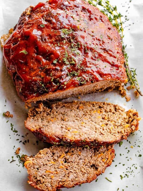 top shot of meatloaf topped with ketchup sauce and dried parsley
