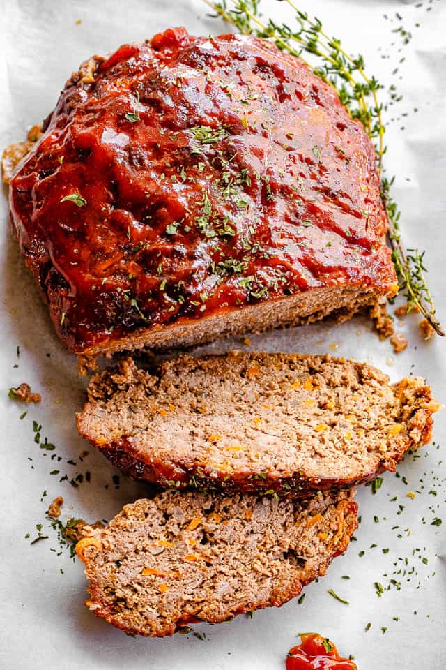 top shot of meatloaf topped with ketchup sauce and dried parsley