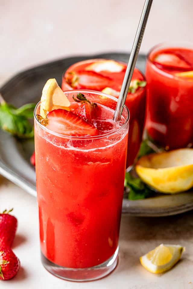 strawberry lemonade sangria in a tall glass with silver straw