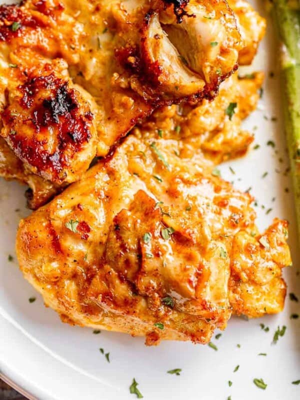 yogurt marinated chicken thighs arranged on a white plate