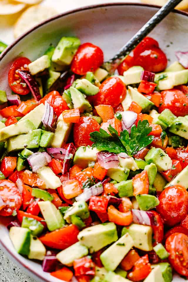 diced tomatoes and avocados in a gray bowl