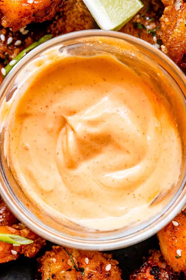 Overhead close-up shot of mayonnaise chili sauce in a small glass bowl.
