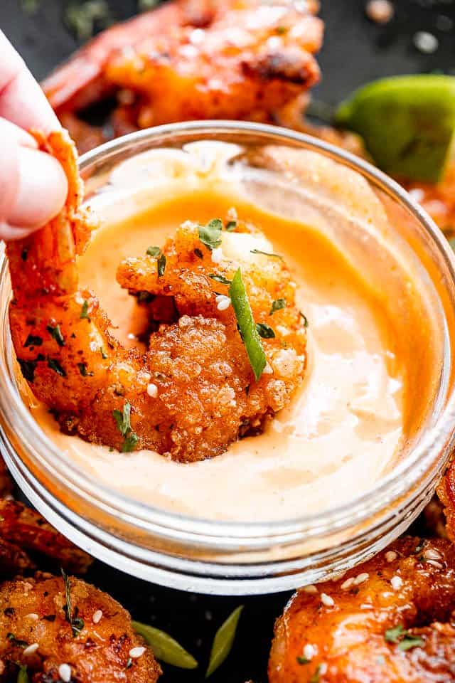 Dipping bang bang shrimp in a mayonnaise chili sauce.