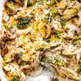 overhead shot of chicken broccoli casserole with a serving spoon inside the baking dish