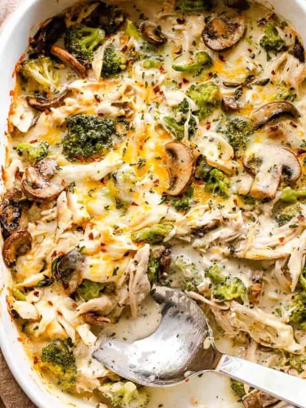 overhead shot of chicken broccoli casserole with a serving spoon inside the baking dish