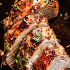 close up shot of slices of pork tenderloin on a dark background