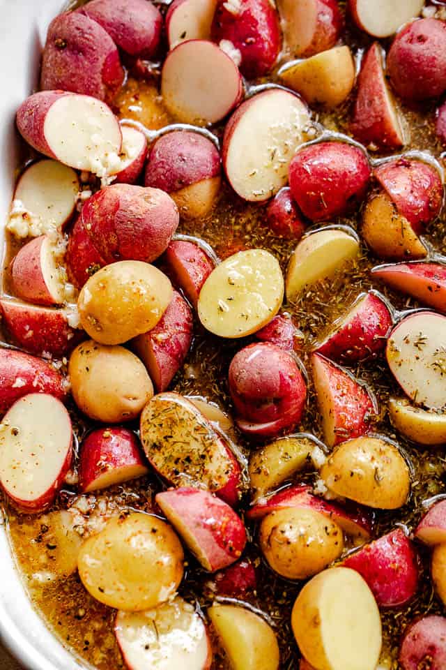 overhead shot of halved small potatoes in lemon garlic marinade