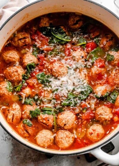 top shot of a white dutch oven filled with meatball soup