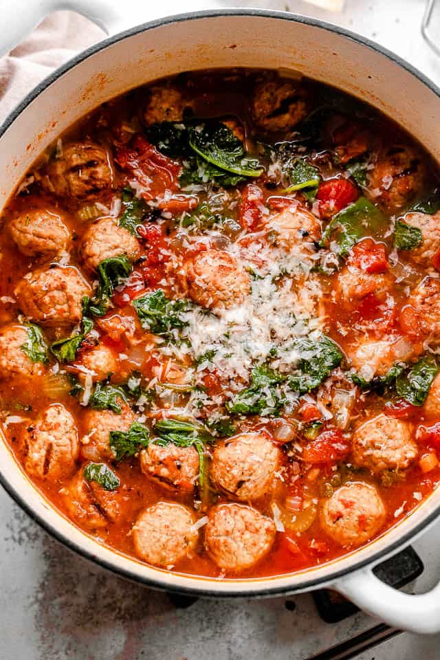 top shot of a white dutch oven filled with meatball soup