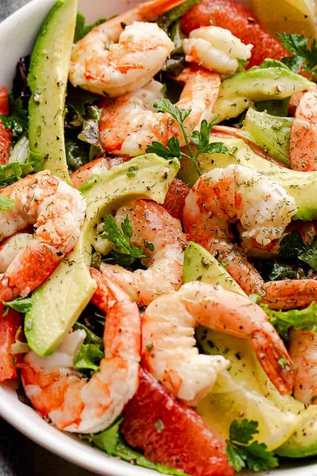 Shrimp and avocados in a white salad bowl