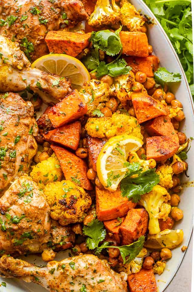 close up shot of cooked and cubed sweet potatoes, chickpeas, and cauliflower florets