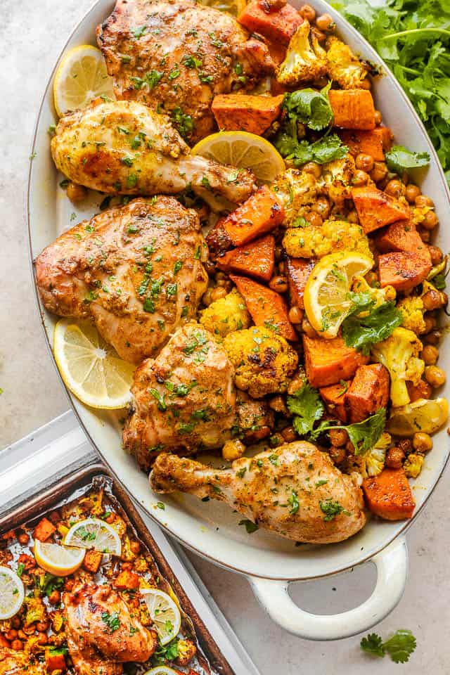 top shot of oval platter with tandoori chicken pieces, sweet potato cubes, and cauliflower florets.