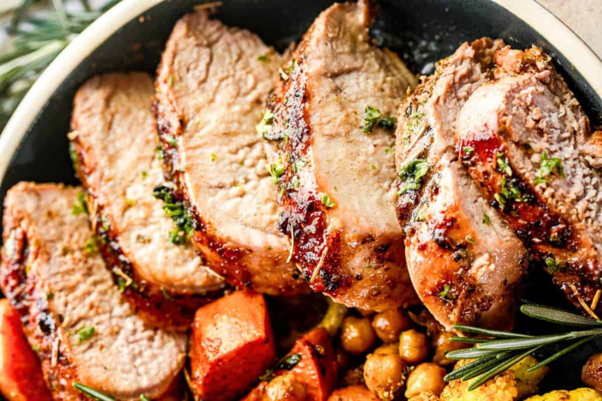This Instant Pot pork tenderloin is tender, juicy, and quick to make, with a savory maple-Dijon garlic sauce and an easy homemade gravy. Instant pot pork tenderloin, sliced, and served in a bowl with chickpeas and sweet potatoes