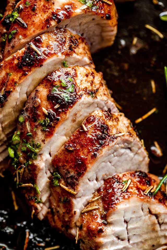 This Instant Pot pork tenderloin is tender, juicy, and quick to make, with a savory maple-Dijon garlic sauce and an easy homemade gravy. Cooked and sliced instant pot pork tenderloin arranged on a dark background.