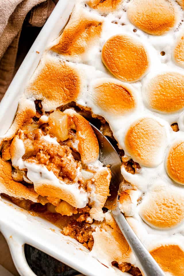 white baking dish with apple crumble topped with marshmallows