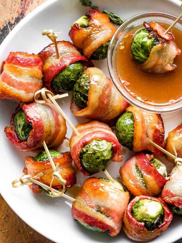 overhead shot of bacon wrapped brussel sprouts in a white bowl