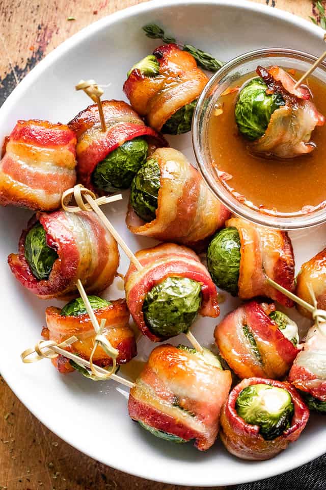 overhead shot of bacon wrapped brussel sprouts in a white bowl