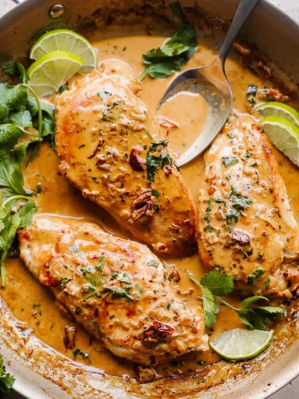 overhead shot of chicken breasts in a skillet with creamy chipotle sauce with cilantro