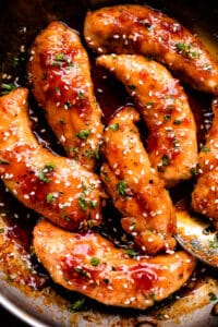 overhead shot of honey garlic chicken tenders in a skillet